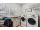 Convenient laundry room with washer, dryer, and built-in workspace at 29512 N Tarragona Dr, Peoria, AZ 85383