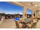 Relaxing patio with outdoor dining area, ceiling fans, and pool views at 29512 N Tarragona Dr, Peoria, AZ 85383