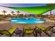 Relaxing pool area with green lounge chairs and shade canopies at 29512 N Tarragona Dr, Peoria, AZ 85383