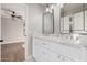 Double vanity bathroom with marble countertop and mirrors at 3040 N Point Ridge Rd, Buckeye, AZ 85396