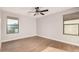 Well-lit bedroom with wood-look floors and mountain views at 3040 N Point Ridge Rd, Buckeye, AZ 85396