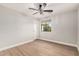 Light and airy bedroom with wood-look floors and window at 3040 N Point Ridge Rd, Buckeye, AZ 85396