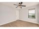 Bright bedroom with wood-look floors and ceiling fan at 3040 N Point Ridge Rd, Buckeye, AZ 85396