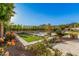 Landscaped backyard with bocce ball court and a pool at 3040 N Point Ridge Rd, Buckeye, AZ 85396