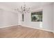 Bright dining room with hardwood floors and chandelier at 3040 N Point Ridge Rd, Buckeye, AZ 85396