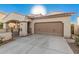 Tan two-story house with a brown door and two-car garage at 3040 N Point Ridge Rd, Buckeye, AZ 85396