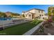 Luxury backyard oasis featuring a sparkling pool, patio, and fire pit at 3040 N Point Ridge Rd, Buckeye, AZ 85396