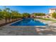 Inviting swimming pool with spacious patio and surrounding landscaping at 3040 N Point Ridge Rd, Buckeye, AZ 85396