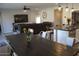 Open concept dining area with dark wood table and view into kitchen and Gathering room at 3094 N 195Th Dr, Buckeye, AZ 85396