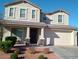 Two-story house with a beige exterior, brown door, and landscaping at 3094 N 195Th Dr, Buckeye, AZ 85396