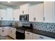 Modern kitchen with white cabinets and stainless steel appliances at 3094 N 195Th Dr, Buckeye, AZ 85396