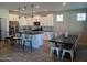 Modern kitchen with white cabinets, dark countertops, and tile backsplash at 3094 N 195Th Dr, Buckeye, AZ 85396