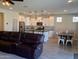 Open concept kitchen with white cabinets, island, and dining area at 3094 N 195Th Dr, Buckeye, AZ 85396