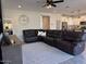 Open living room with sectional sofa and large TV at 3094 N 195Th Dr, Buckeye, AZ 85396