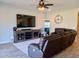 Living Room with large TV, sectional sofa, and tile flooring at 3094 N 195Th Dr, Buckeye, AZ 85396