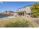 Landscaped backyard with a pool and two-story house in the background at 3151 E Turnberry Dr, Gilbert, AZ 85298