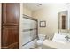 Simple bathroom with a shower/tub combo and wood cabinets at 3151 E Turnberry Dr, Gilbert, AZ 85298