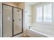 Clean bathroom with a shower/tub combo and a window with plantation shutters at 3151 E Turnberry Dr, Gilbert, AZ 85298