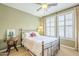 Charming bedroom with a metal bed frame and a ceiling fan at 3151 E Turnberry Dr, Gilbert, AZ 85298