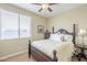 Bedroom with a wooden bed frame and ceiling fan at 3151 E Turnberry Dr, Gilbert, AZ 85298