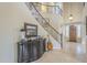 Grand entryway with curved staircase, tile flooring, and a dark wood console table at 3151 E Turnberry Dr, Gilbert, AZ 85298