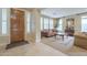 Living room with tiled floors, wooden furniture, and large windows at 3151 E Turnberry Dr, Gilbert, AZ 85298