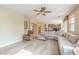 Relaxing living room features L-shaped sofa, wood-look floors, and ceiling fan at 3151 E Turnberry Dr, Gilbert, AZ 85298