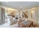 Living room with a staircase, wooden furniture, and large windows at 3151 E Turnberry Dr, Gilbert, AZ 85298