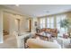 Living room with tiled floors, wooden furniture, and large windows at 3151 E Turnberry Dr, Gilbert, AZ 85298