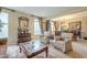 Living room with tiled floors, wooden furniture, and large windows at 3151 E Turnberry Dr, Gilbert, AZ 85298