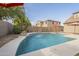 Curved swimming pool with water features, surrounded by a patio at 3151 E Turnberry Dr, Gilbert, AZ 85298