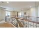 Bright upper hallway with curved railing and views to the entryway below at 3151 E Turnberry Dr, Gilbert, AZ 85298