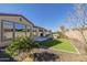 Landscaped backyard with artificial turf and a hot tub at 316 E Leverenz Ave, Queen Creek, AZ 85140