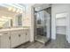 Modern bathroom with a glass shower, dual vanity, and walk-in closet at 316 E Leverenz Ave, Queen Creek, AZ 85140