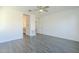 Spacious bedroom featuring wood-look tile floors and ceiling fan at 316 E Leverenz Ave, Queen Creek, AZ 85140