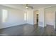 Bright bedroom with wood-look tile floors and plantation shutters at 316 E Leverenz Ave, Queen Creek, AZ 85140