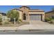 Brick home with a two-car garage and landscaped front yard at 316 E Leverenz Ave, Queen Creek, AZ 85140