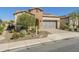 Brick home with a two-car garage and landscaped front yard at 316 E Leverenz Ave, Queen Creek, AZ 85140