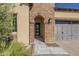 Elegant front entry with a brick archway and tile walkway at 316 E Leverenz Ave, Queen Creek, AZ 85140