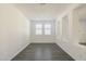 Bright room with white walls, gray tile floors, and white shutters at 316 E Leverenz Ave, Queen Creek, AZ 85140