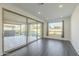 Bright interior room features dark gray tile floors and sliding glass doors leading to the backyard at 316 E Leverenz Ave, Queen Creek, AZ 85140