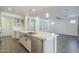 Modern kitchen with large island, stainless steel appliances, and farmhouse sink at 316 E Leverenz Ave, Queen Creek, AZ 85140