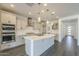 Modern kitchen with white cabinets, large island, and stainless steel appliances at 316 E Leverenz Ave, Queen Creek, AZ 85140