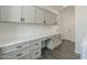 Laundry room with built-in cabinetry and workspace at 316 E Leverenz Ave, Queen Creek, AZ 85140