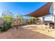 Backyard patio with shade sail and landscaping at 31828 N Ash St, Wittmann, AZ 85361