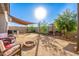 Backyard view with fire pit and shade sail at 31828 N Ash St, Wittmann, AZ 85361