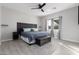 Main bedroom with a ceiling fan, large window, and plush bedding at 31828 N Ash St, Wittmann, AZ 85361