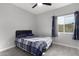 Guest bedroom with a bed, window, and tile floor at 31828 N Ash St, Wittmann, AZ 85361