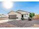 New construction home with a two-car garage and desert landscaping at 31828 N Ash St, Wittmann, AZ 85361