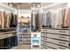 Large walk-in closet with ample shelving and drawers at 32633 N 137Th St, Scottsdale, AZ 85262